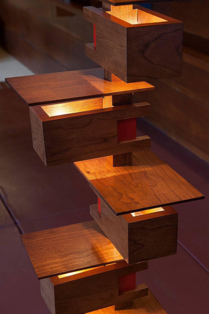 Close up of Taliesin Floor Lamp, cherry stain, with lights on