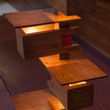 Close up of Taliesin Floor Lamp, cherry stain, with lights on