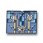 Decorative pin with floral design on a white background