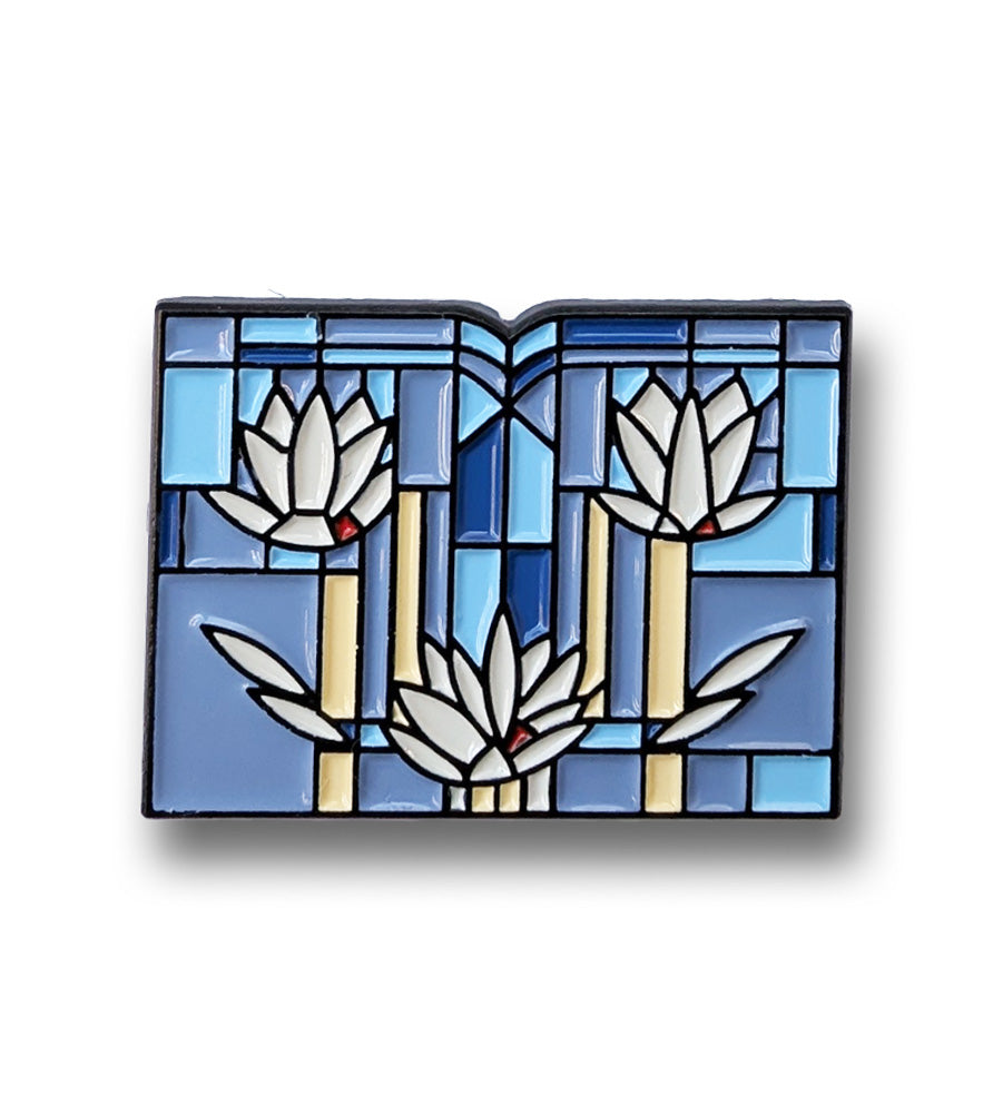 Decorative pin with floral design on a white background