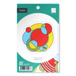 Packaged sticker with colorful geometric design on a green background